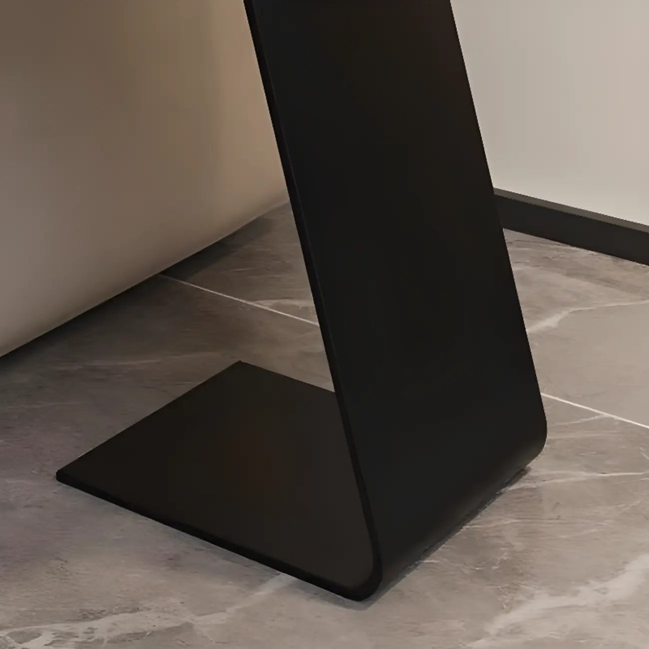 Table d'appoint ronde en marbre avec base en métal noir et forme en C, idéale pour un canapé.