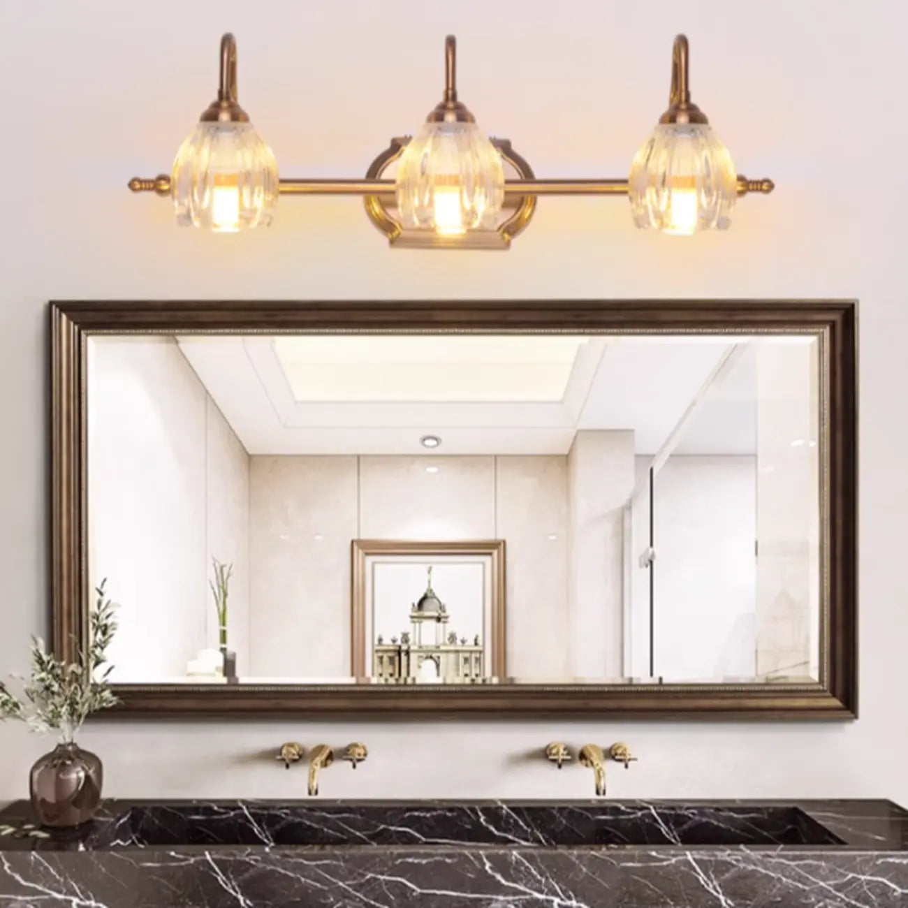 Applique murale moderne à trois lampes en laiton avec globe, à placer au-dessus du miroir.