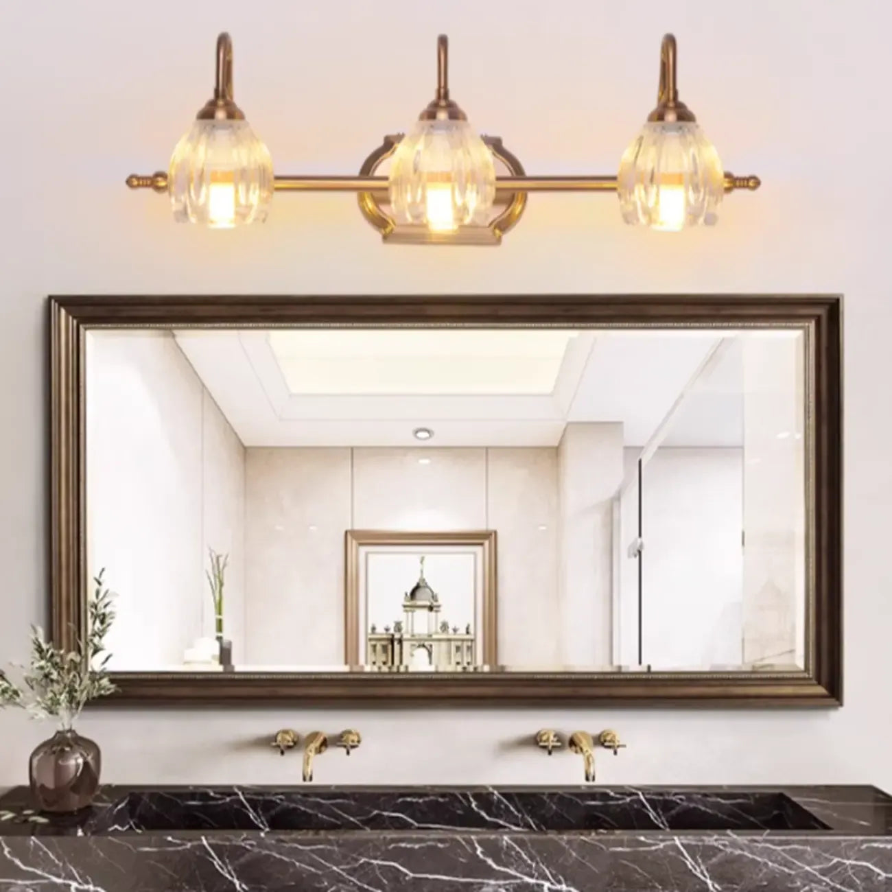 Applique murale moderne à trois lampes en laiton avec globe, à placer au-dessus du miroir.