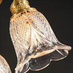 Suspension géométrique en laiton avec verre à motif floral.