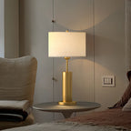Lampe de table en forme de tonneau, en métal doré et tissu, à brancher