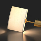 Lampe de table en forme de tonneau, en métal doré et tissu, à brancher