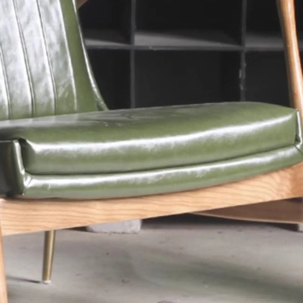Fauteuil moderne en cuir vert avec dossier haut