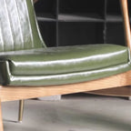Fauteuil moderne en cuir vert avec dossier haut