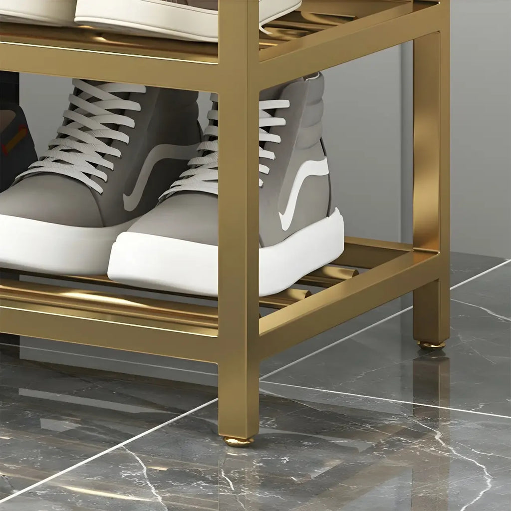 Étagère à chaussures grise capitonnée avec cadre doré pour entrée