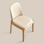 Chaise de salle à manger à dossier plein en bois crème et similicuir.