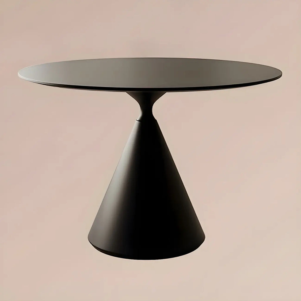 Table de salle à manger ronde avec plateau en pierre et piètement en métal, idéale pour les petits espaces.