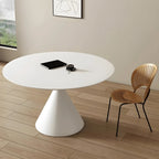 Table de salle à manger ronde avec plateau en pierre et piètement en métal, idéale pour les petits espaces.