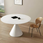 Table de salle à manger ronde avec plateau en pierre et piètement en métal, idéale pour les petits espaces.