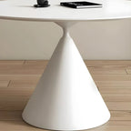 Table de salle à manger ronde avec plateau en pierre et piètement en métal, idéale pour les petits espaces.