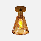 Plafonnier semi-encastré moderne en laiton et verre ambré, forme conique.