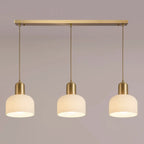 Luminaire cylindrique moderne en verre blanc et or pour îlot de cuisine