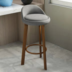Tabouret de bar élégant et confortable, revêtu de tissu.
