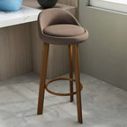 Tabouret de bar élégant et confortable, revêtu de tissu.