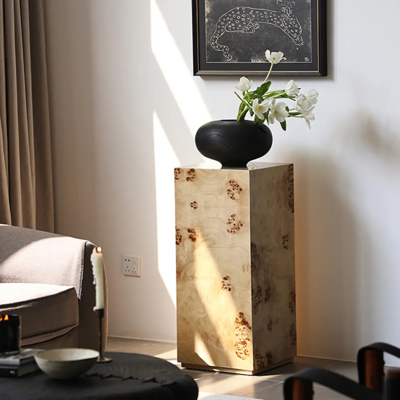Table d'appoint cylindrique en bois clair avec piètement bloc.