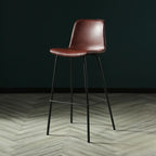 Tabouret de bar industriel en cuir avec structure métallique et repose-pieds
