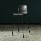 Tabouret de bar industriel en cuir avec structure métallique et repose-pieds