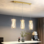 Suspension cylindrique en cristal pour îlot de cuisine, éclairage LED à intensité variable.
