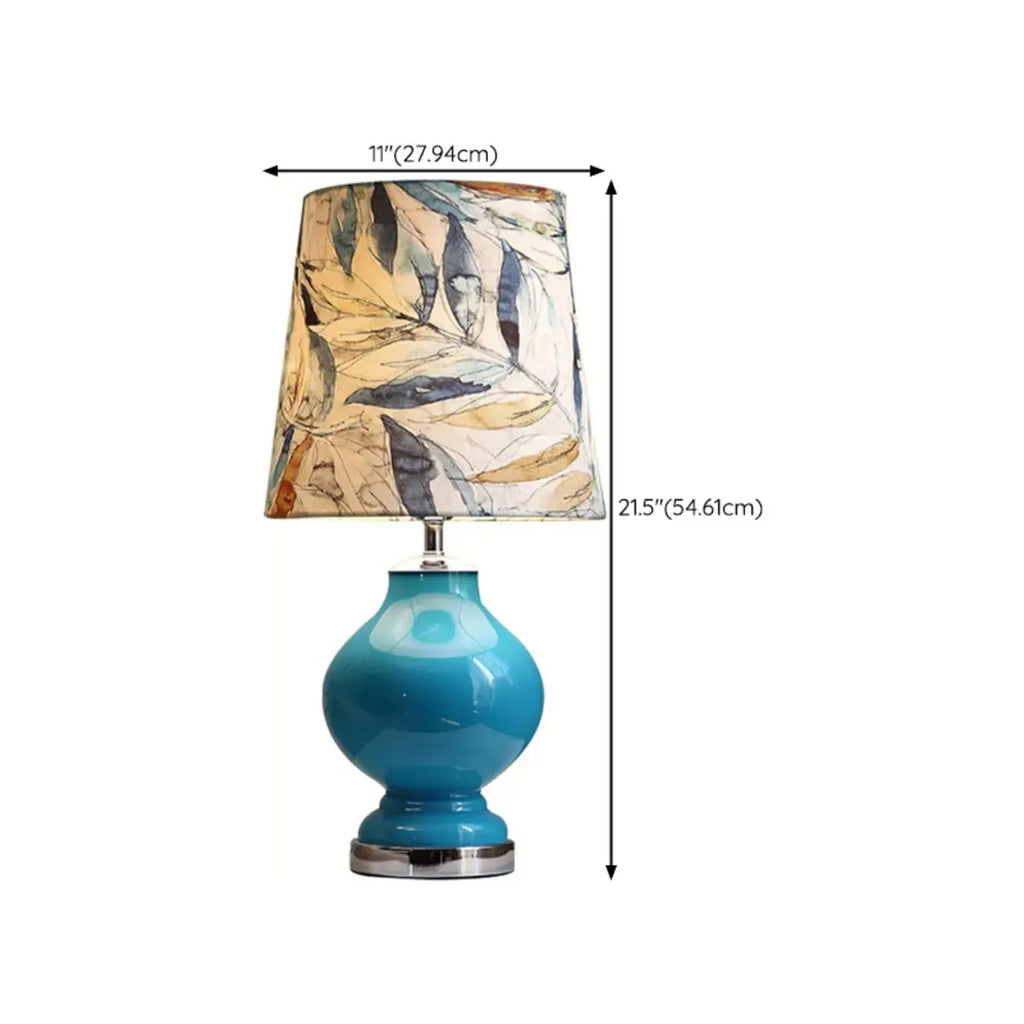 Lampe de table en verre bleu avec abat-jour en tissu à motif de feuilles