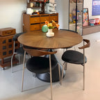 Table de salle à manger moderne ronde en bois brun avec piètement conique en métal