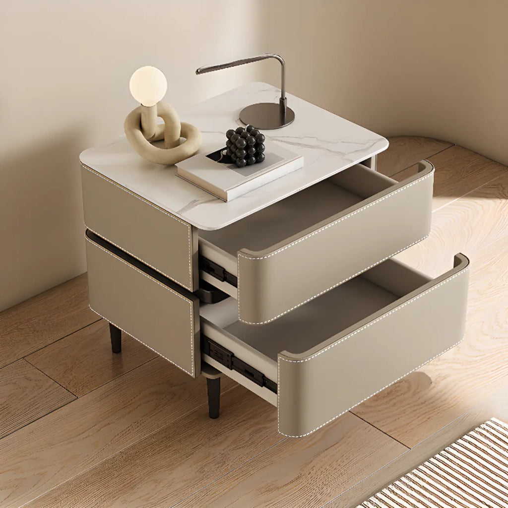 Table de chevet moderne à deux tiroirs arrondis avec plateau en simili marbre et revêtement en cuir