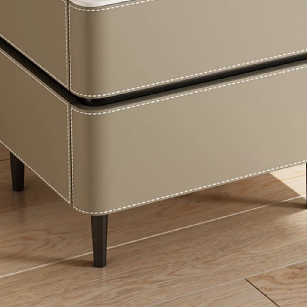 Table de chevet moderne à deux tiroirs arrondis avec plateau en simili marbre et revêtement en cuir