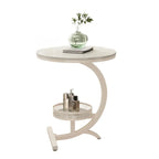 Table d'appoint en forme de C avec plateau en pierre et piètement en métal.