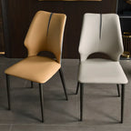 Chaise de salle à manger moderne sans accoudoirs, dossier ouvert, en similicuir.