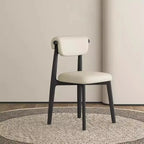 Chaise de salle à manger élégante à dossier bas, revêtue de similicuir.