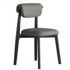 Chaise de salle à manger élégante à dossier bas, revêtue de similicuir.