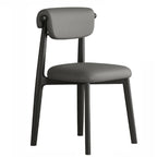 Chaise de salle à manger élégante à dossier bas, revêtue de similicuir.