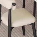 Chaise de salle à manger élégante à dossier bas, revêtue de similicuir.