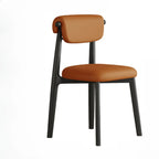 Chaise de salle à manger élégante à dossier bas, revêtue de similicuir.