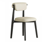 Chaise de salle à manger élégante à dossier bas, revêtue de similicuir.